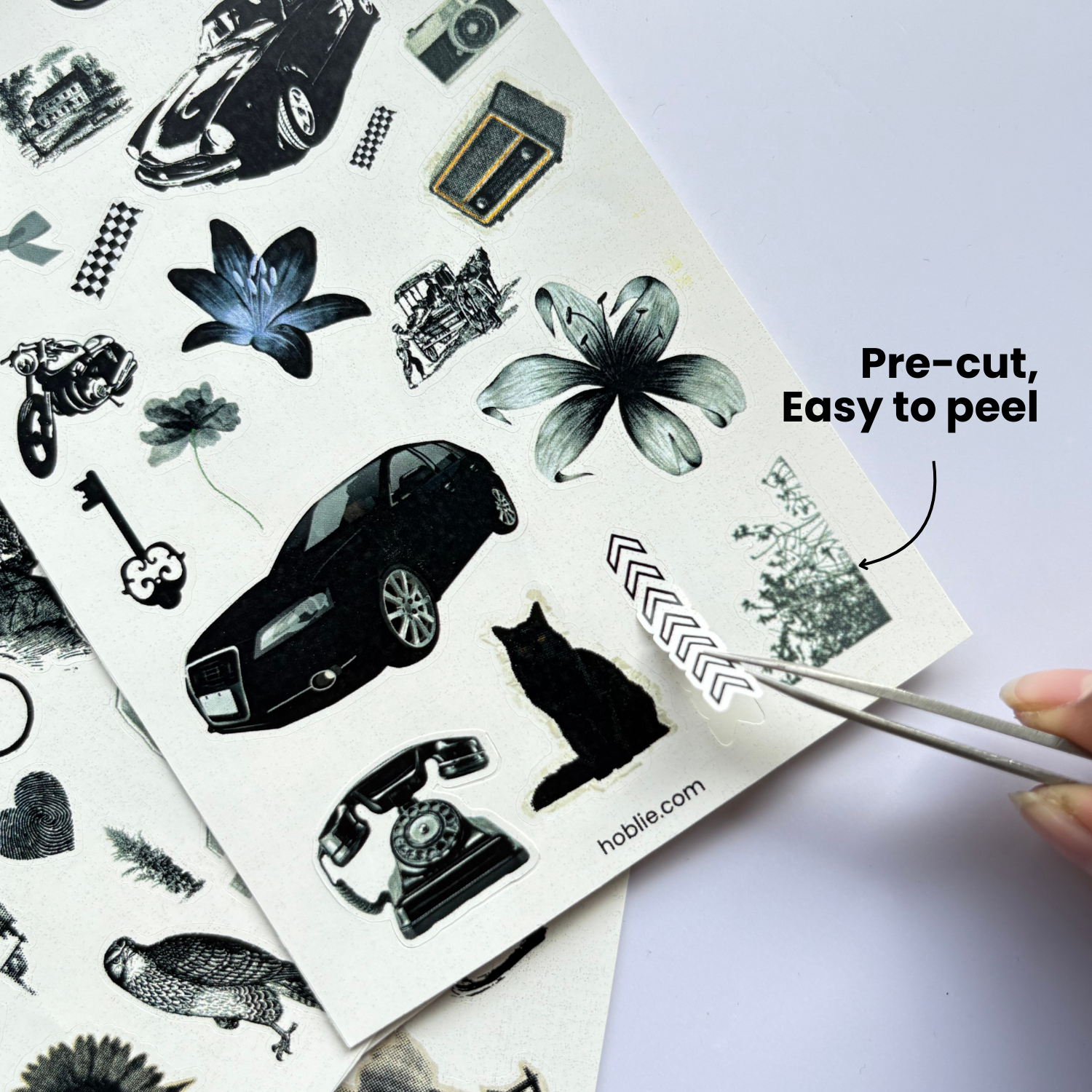 Sheet of pre-cut temporary tattoos with various designs, including cars, flowers, and animals, on a white background.