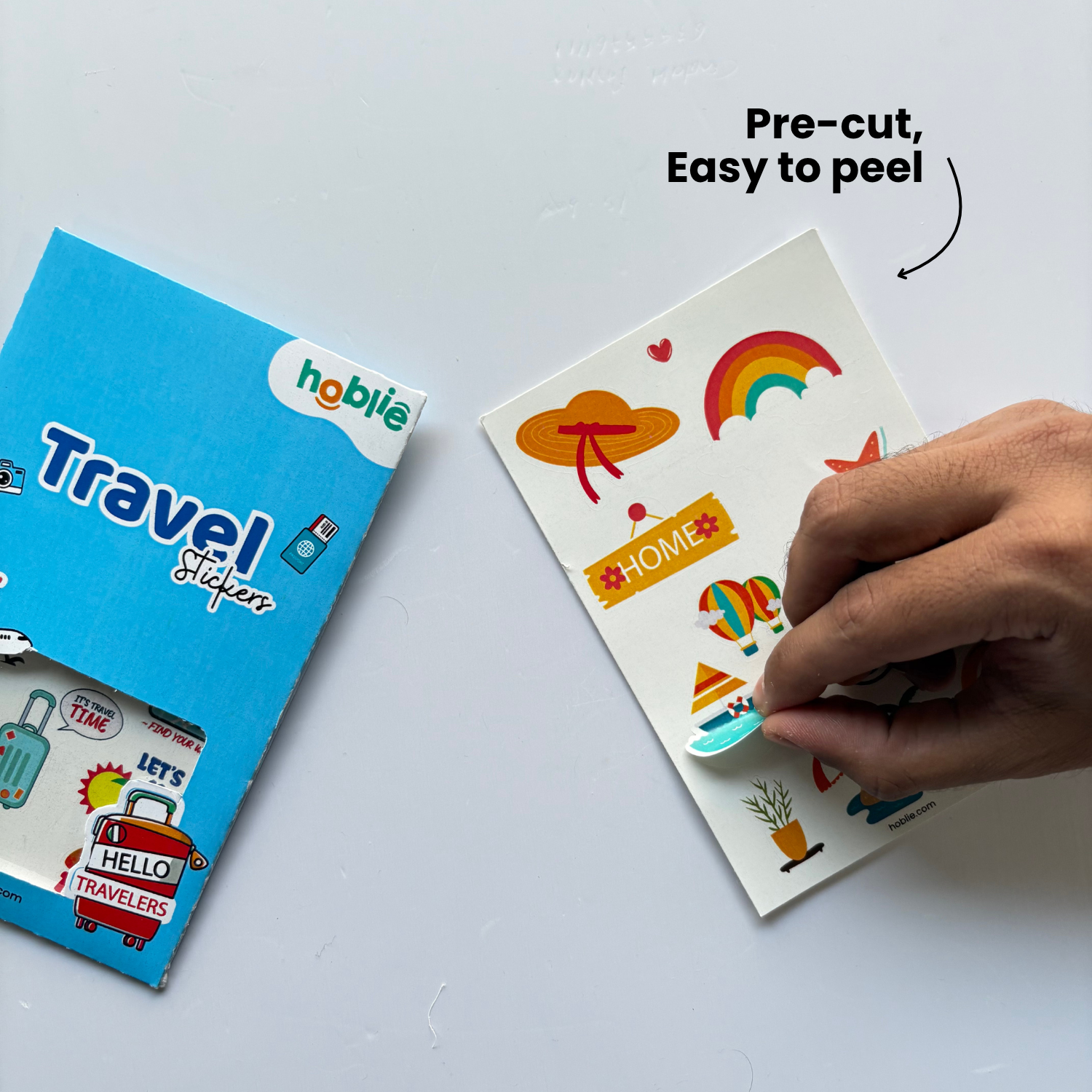  travel stickers with a hand peeling off a sheet.