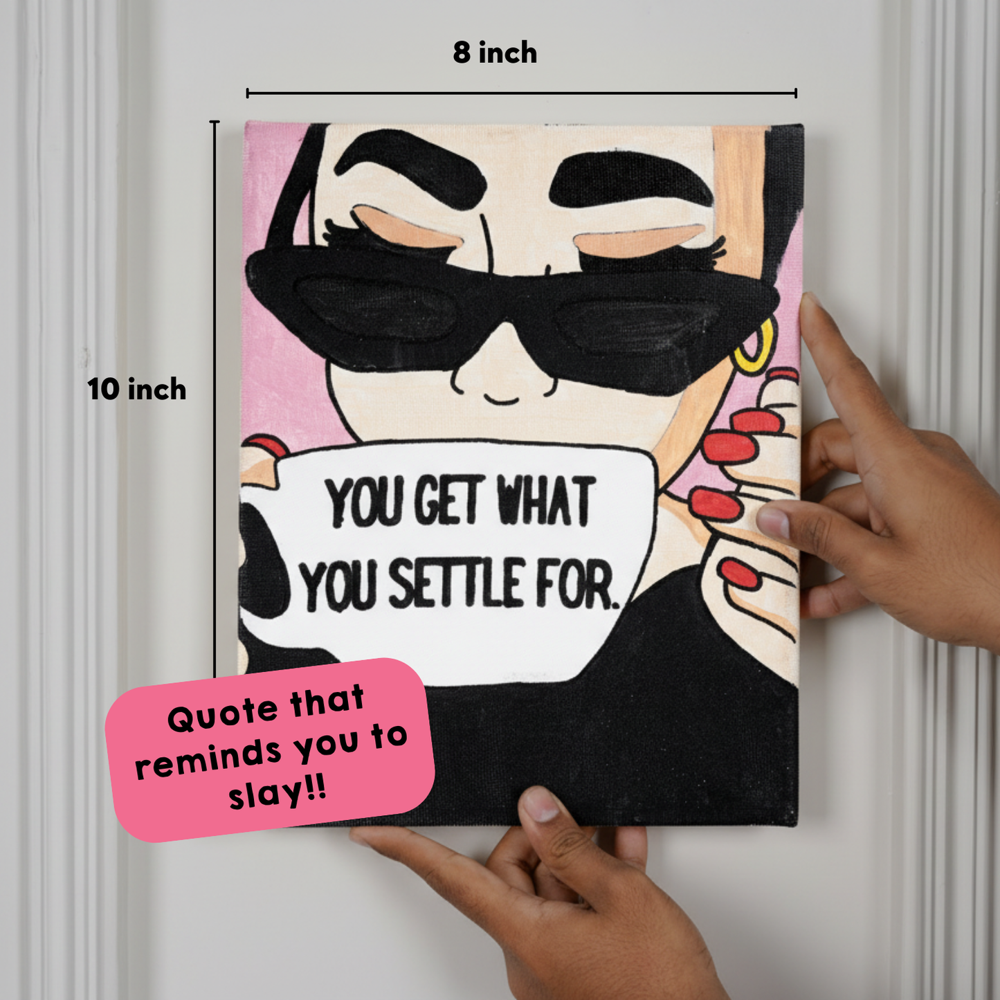 A canvas with a quote and its size details, held in hands against a white wall.