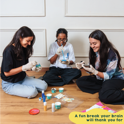 people having fun while doing fluid painting on coasters. The best DIY Kits for Adults - india
