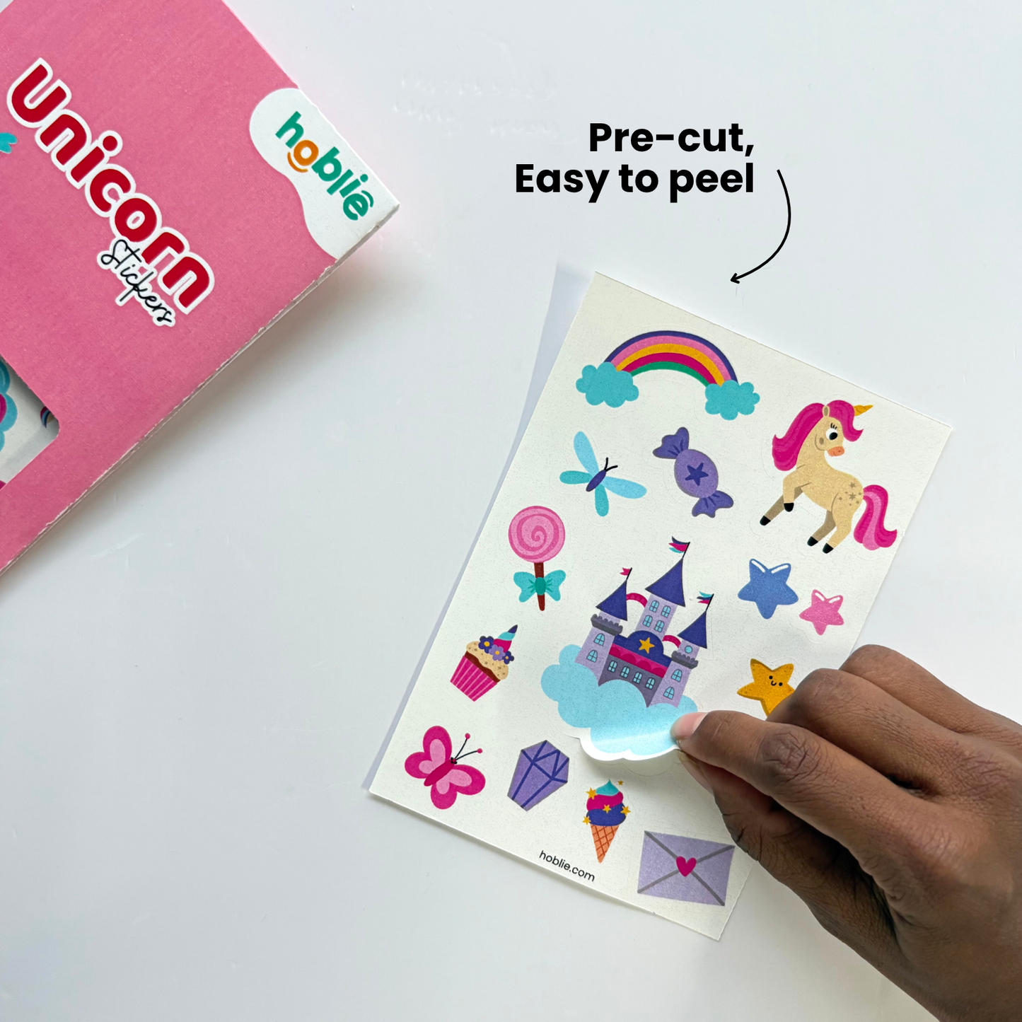unicorn stickers with a hand holding a sheet of stickers.