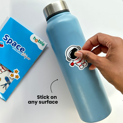 Light blue water bottle with a sticker being applied, next to a 'Space Theme Sticker'
