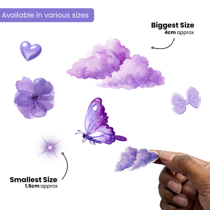 Purple decorative items of various sizes with a hand holding the smallest item, on a white background.